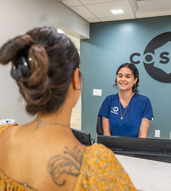 Woman checking in at front desk