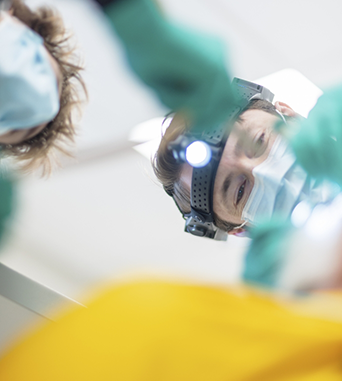 Oral surgeon looking at a patients teeth