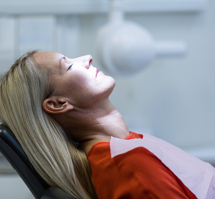 Woman relaxing in dental chair because of anesthesia in Lancaster