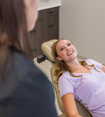 Woman leaning back in dental treatment chair