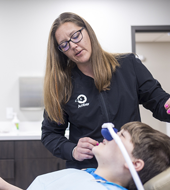 Young man in treatment chair wearing a nose mask for nitrous oxide