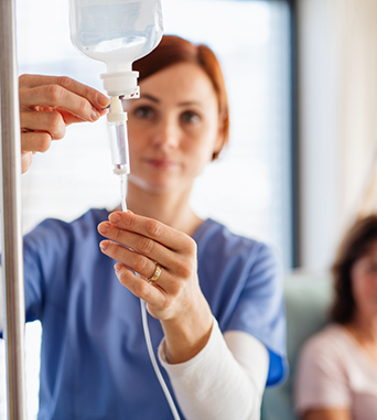 Nurse adjusting an I V