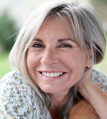 Smiling woman with long straight gray hair