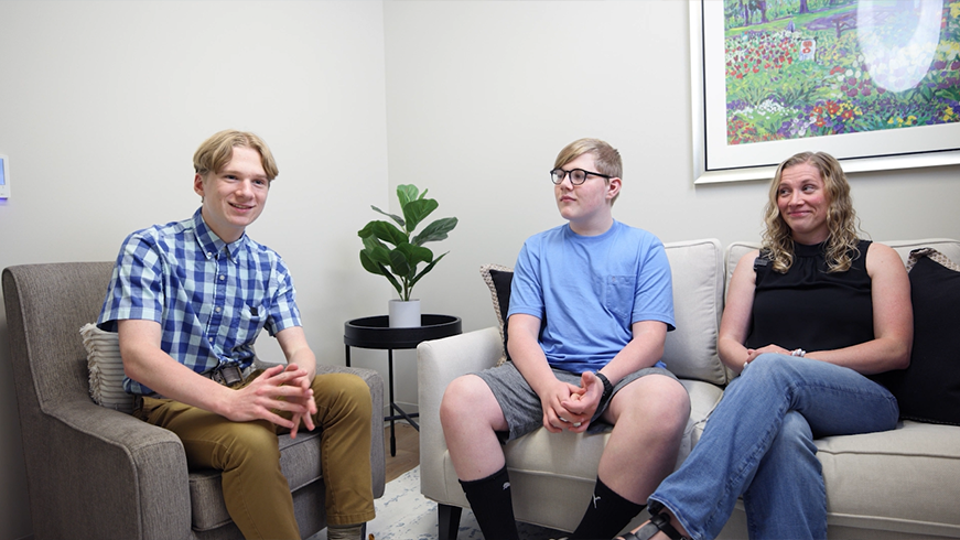 Woman with her two sons sitting in armchairs