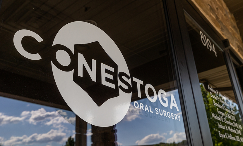 Conestoga Oral Surgery logo on the outside of a glass door