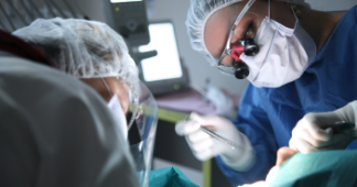 Oral surgeon and assistant performing a procedure on a patient